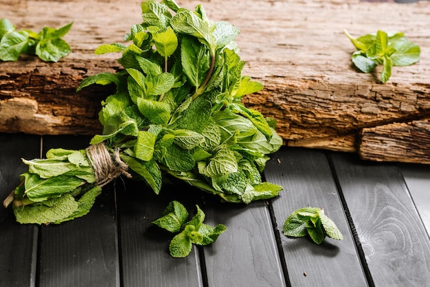 A bunch of raw fresh green mint on wooden background