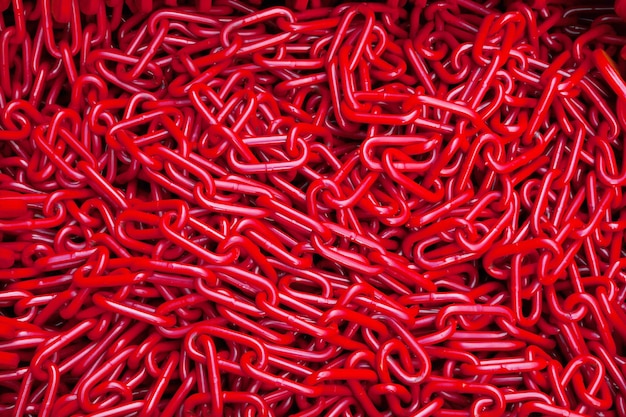 A bunch of red chains closeup Texture and background of chains