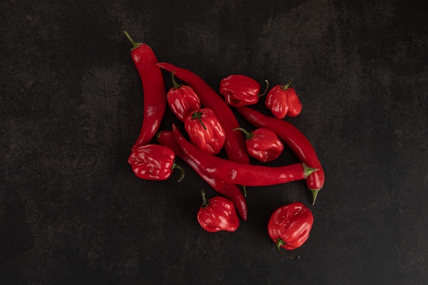 Bunch of red peppers on a black slate