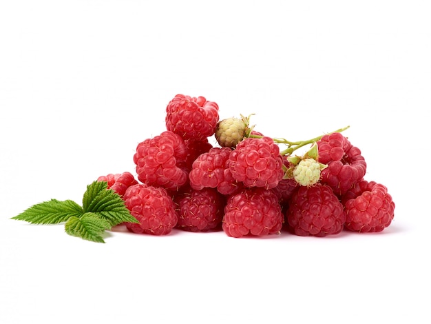 Bunch of red ripe raspberries and green leaf on white