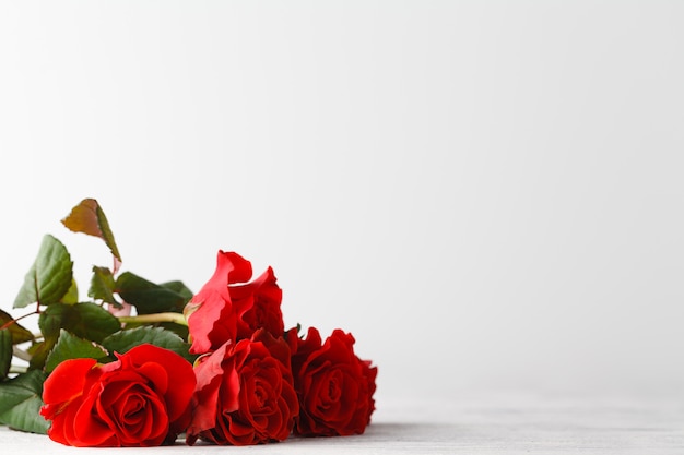 Bunch of red roses on table