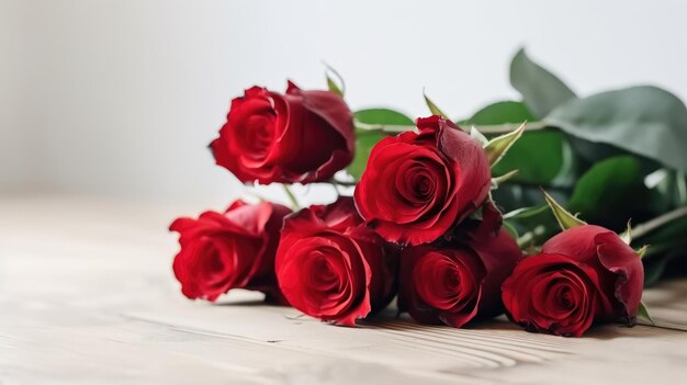 A bunch of red roses on a wooden table