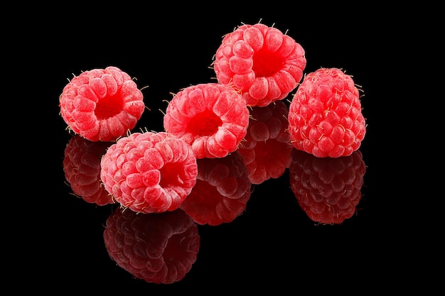 A bunch of ripe raspberries on black background