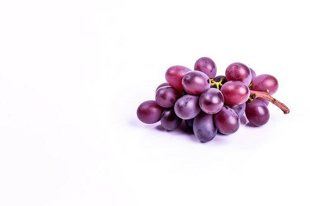 Bunch of ripe red grapes isolated on white background with copy space