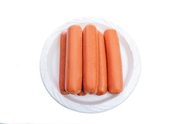 A bunch of sausages on a plastic plate Fast food and junk food Closeup Isolated on white background