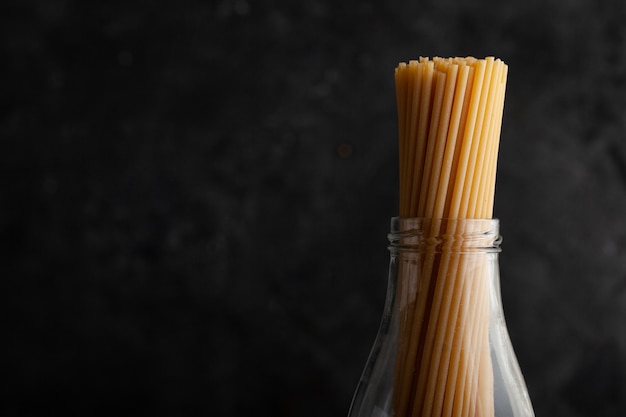 Bunch of spaghetti pasta on dark concrete background