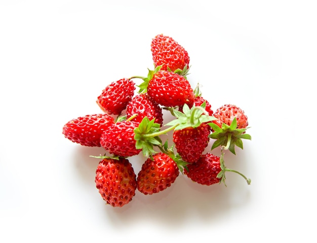 A bunch of strawberry berries top view isolated white