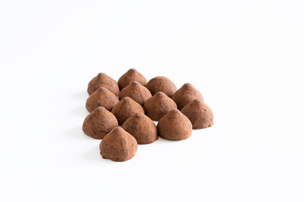 A bunch of sweet chocolate truffles whit chocolate powder  