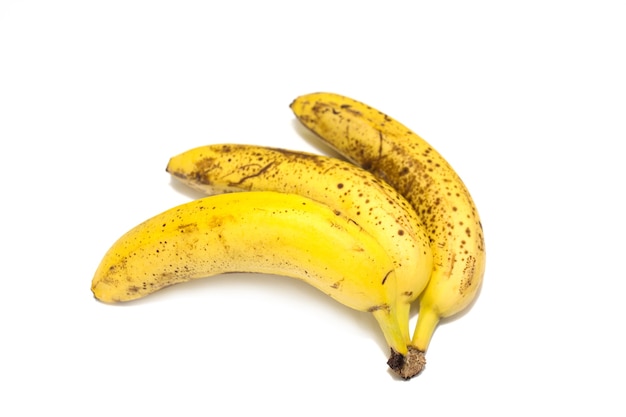 A bunch of three overripe bananas close-up isolated on a white background. High quality photo