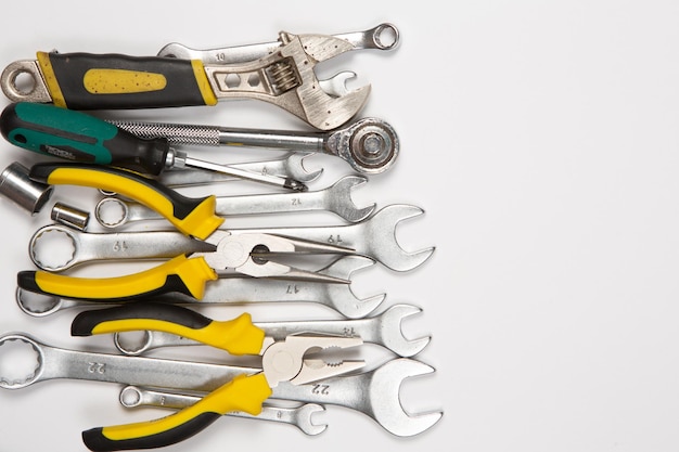 A bunch of tools are laying on a white surface