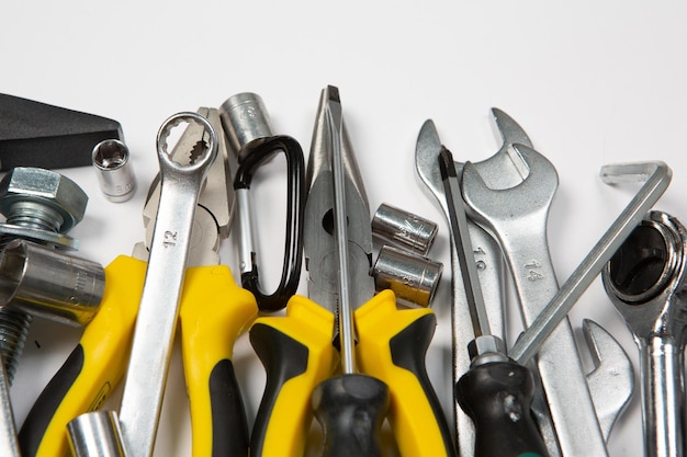 A bunch of tools are laying on a white surface