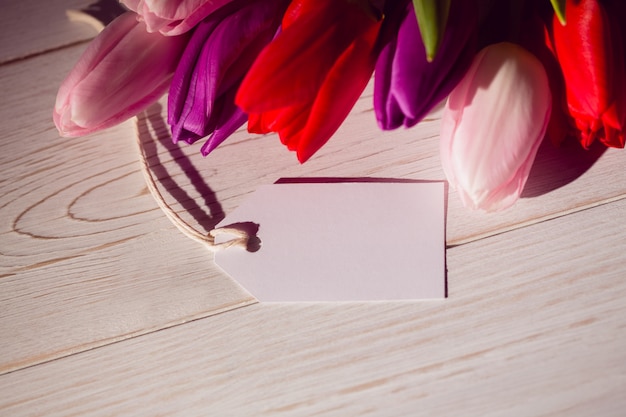 Bunch of tulips and white card