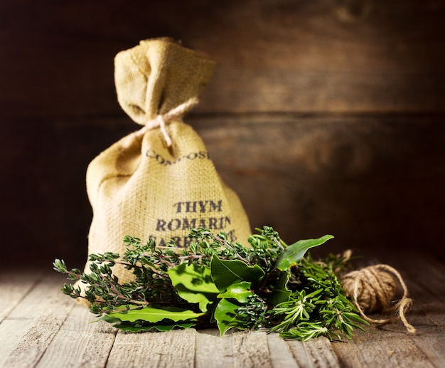 Bunch of various herbs on wooden table