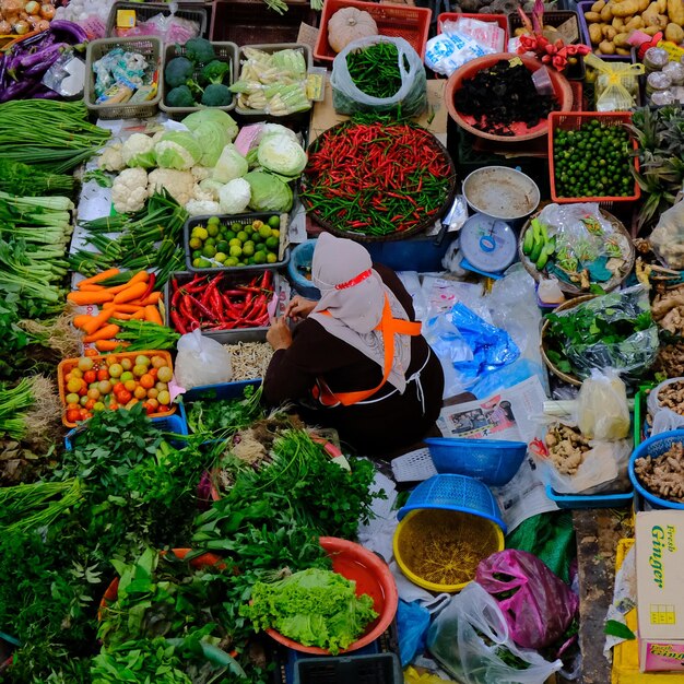 A bunch of vegetables are on display in a market.