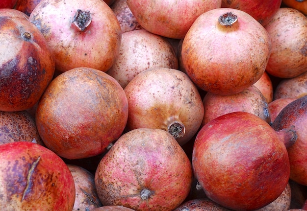 a bunch of whole pomegranate fruit