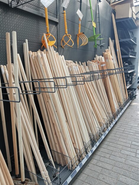 A bunch of wooden sticks are lined up against a wall