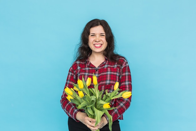 Bunch of yellow tulips on woman's hands