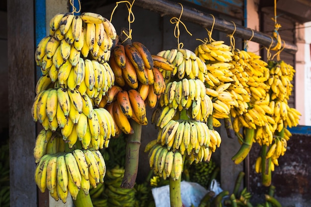 Bunches of bananas fresh cut from a tree on sale in the market in asia banana varieties street