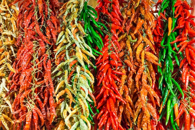 Bunches of red and green hot chilly peppers on the farmers market