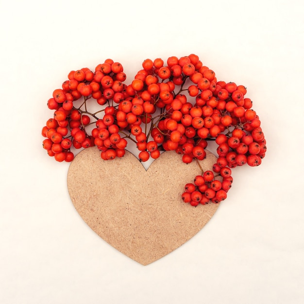 Bunches of rowan berries with bright rich orange juicy berries and heart with copy space