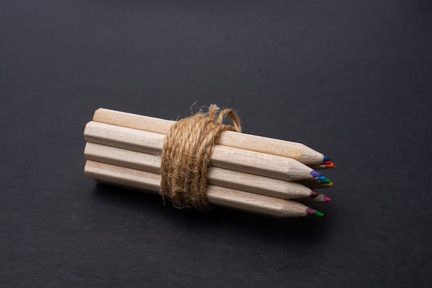 Bundle of colored pencils wrapped with linen string