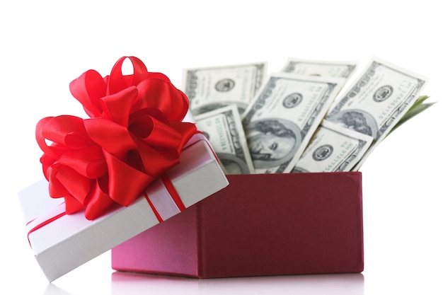 Bundle of dollars in present box with bow isolated on white surface