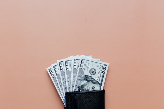 Bundle of dollars in purse on beige background. High quality photo