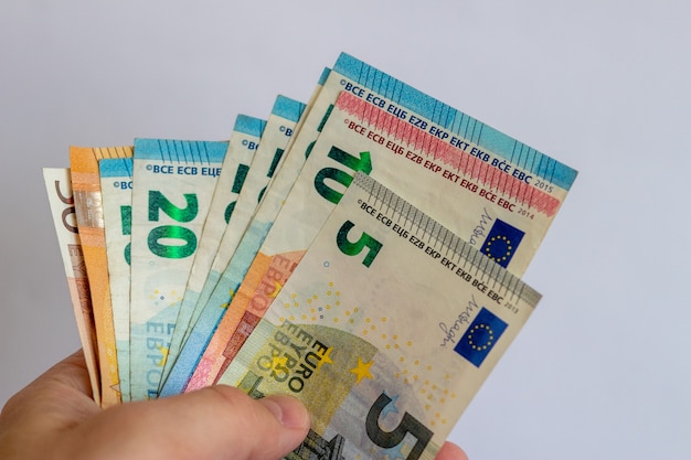 A bundle of euros in the hands on a white background Euro bills on a white background