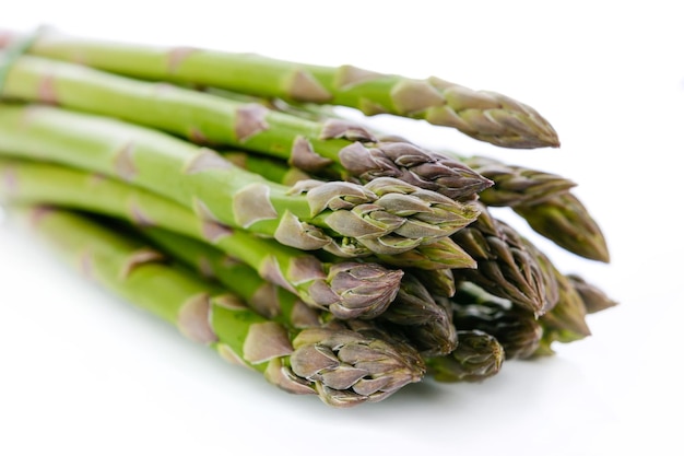 Bundle of fresh and green asparagus isolated on white background in closeup