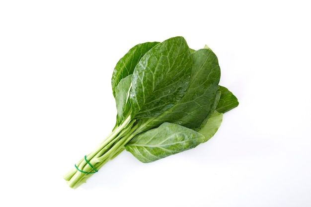 Bundle of water drops on fresh Chinese kale vegetable on white background