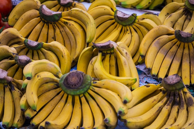 Bundles of bananas in a shop window, market.