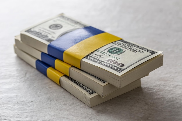 Bundles of dollar bills tied with the Ukrainian flag