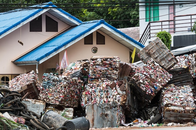 Photo bundles of garbage against building