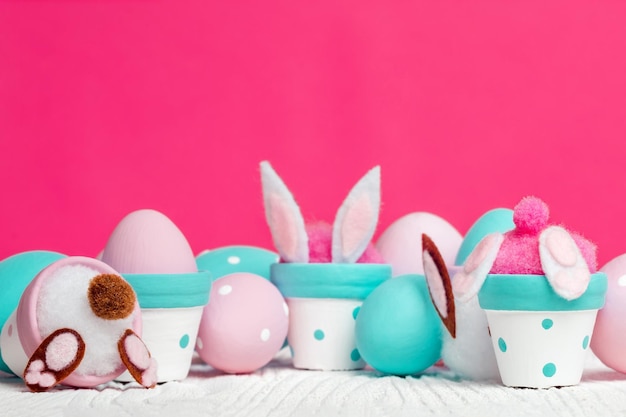 The bunny in the flower pot cute Easter decoration on white wooden background