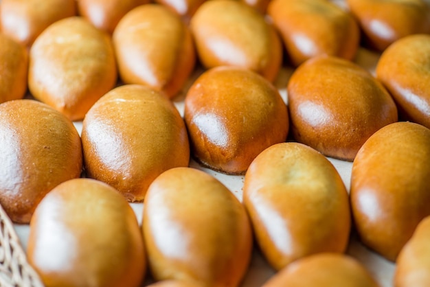 Buns and pastries in a basket on the bakery shop window