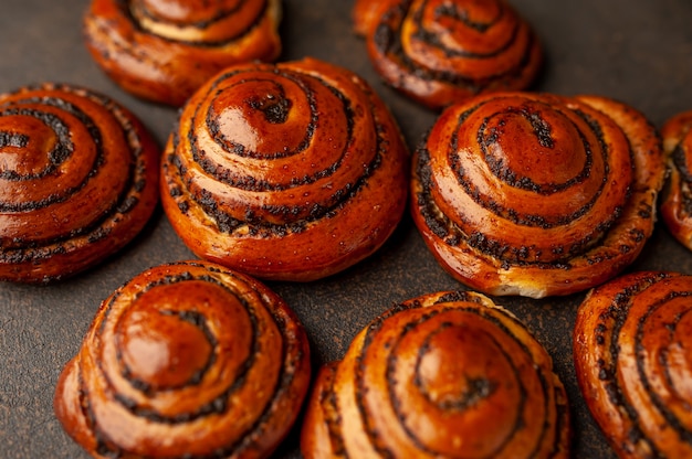 buns with poppy seeds on a stone background