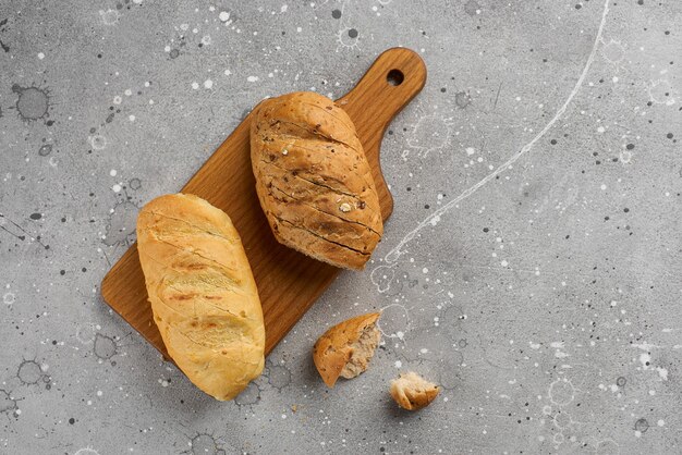 Buns with seeds and grain on a stone texture