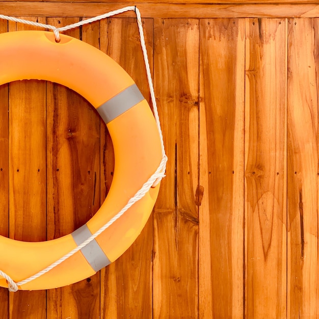 Buoy hanging on the wall of the ship made of wood