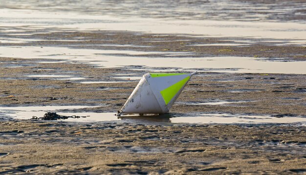 Buoy on the sandy beach on the north sea in sankt peter-ording