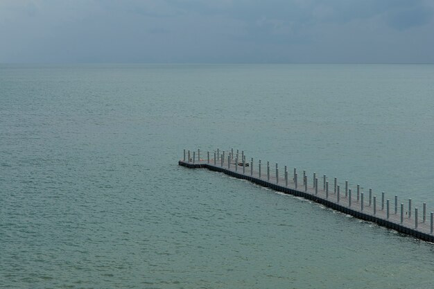 The buoy walkway extends into the sea.