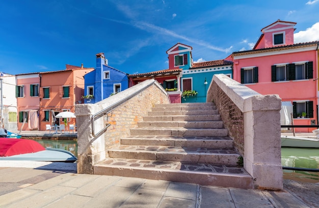 Burano Italy with colorful painted houses along canal with boats Scenic Italian town near Venice