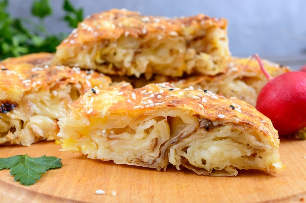 Burek Turkish pie. Lavash puff pie with cheese and sesame seeds