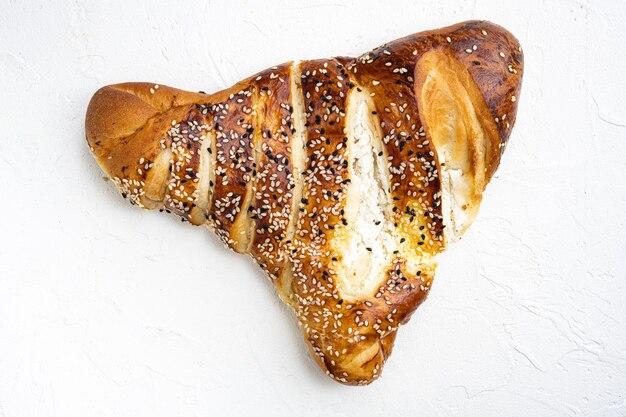 Photo burekas triangle filled with cheese painir on white stone table background top view flat lay