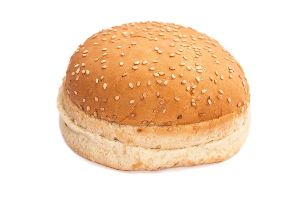 Burger bun with sesame seeds on white background