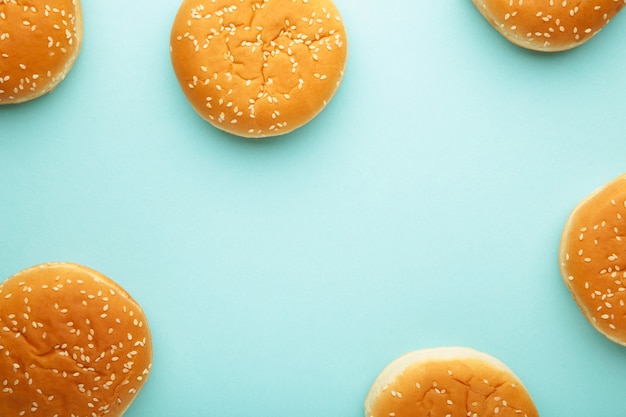 Photo the burger buns on a blue background. top view.