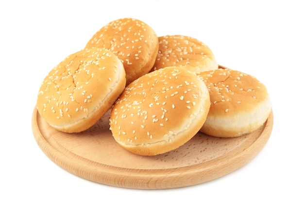 Burger buns on cutting board isolated on a white background. Top view.