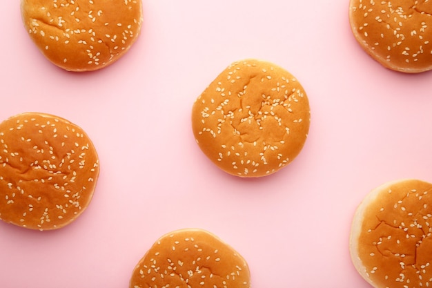 The burger buns on a pink background. Top view.