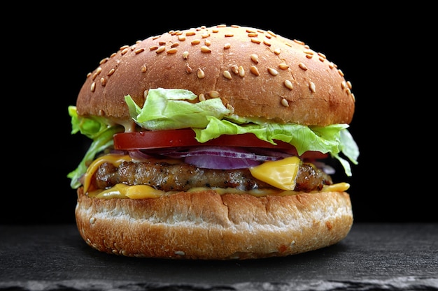 Burger, cheeseburger, hamburger with meat cutlet, cheese, lettuce and tomato