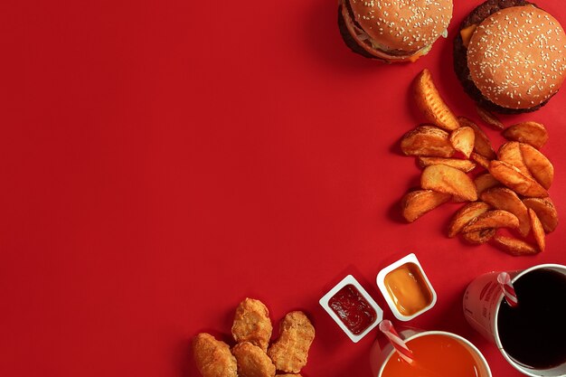 Burger and chips hamburger and french fries in red paper box fast food on red background