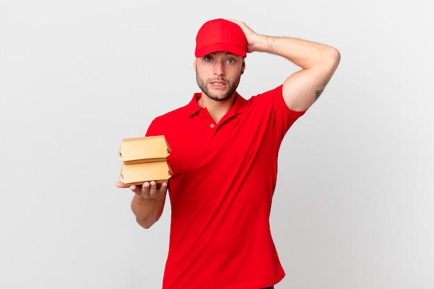 Burger deliver man feeling stressed, anxious or scared, with hands on head